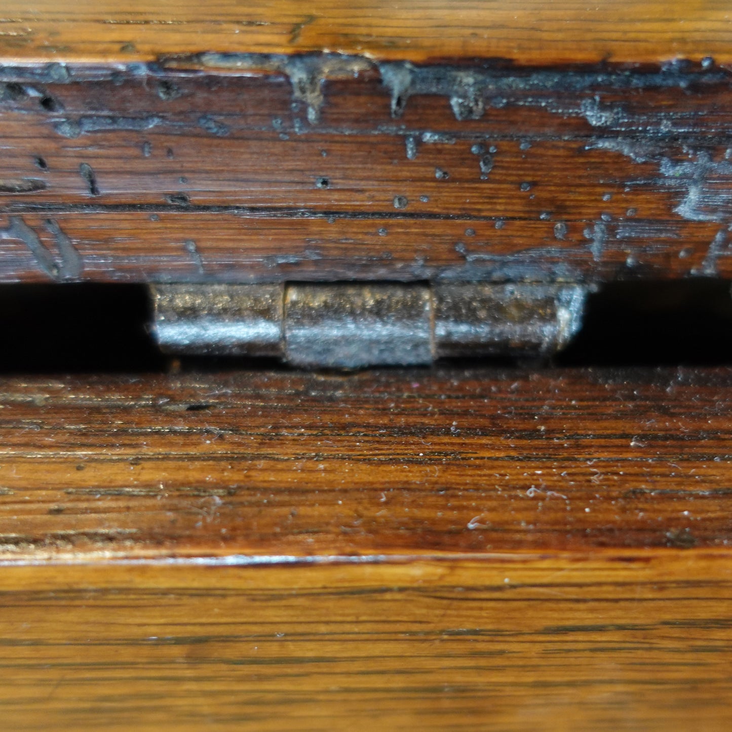 Close-up of a wooden surface with a metal latch