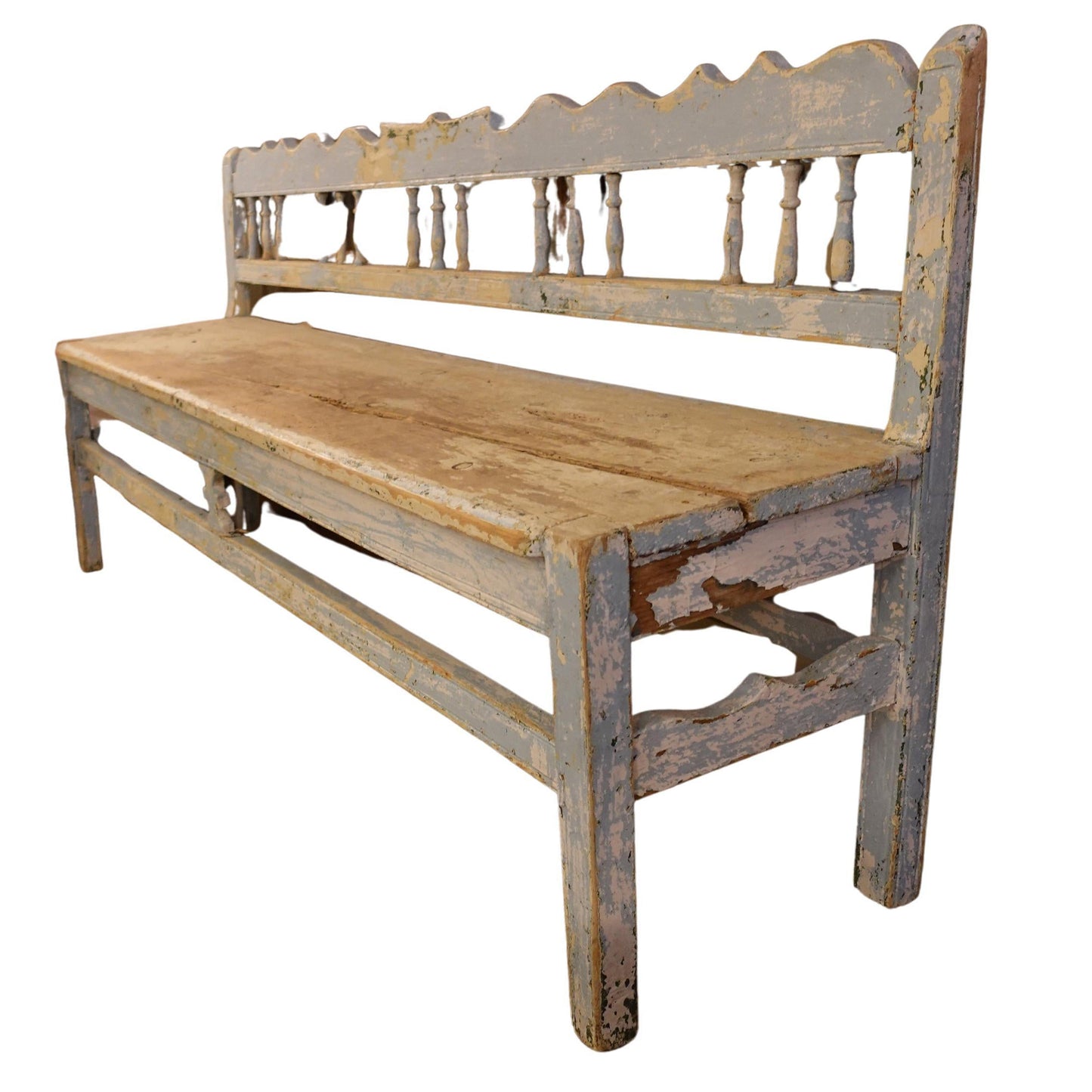 Vintage wooden bench with a scalloped backrest on a white background