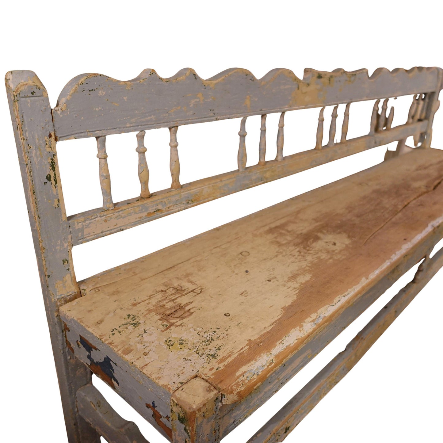 Worn wooden bench with decorative backrest on a white background