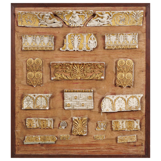 Collection of decorative architectural elements on a wooden board