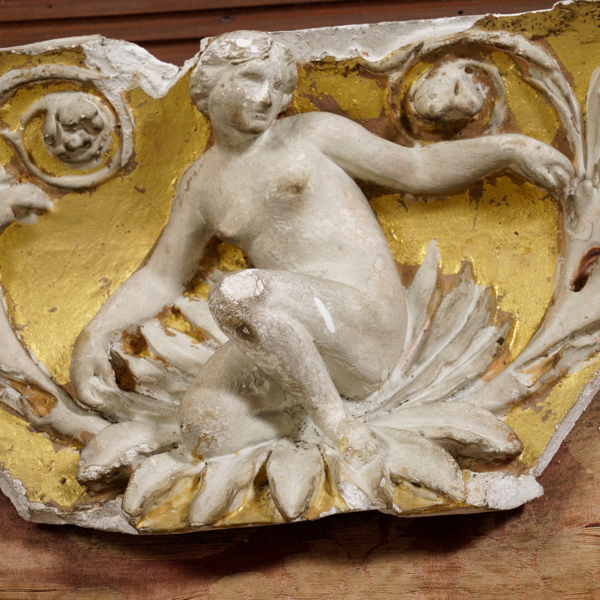 Detail of partially gilt plaster decorative moulding depicting a woman on a flower