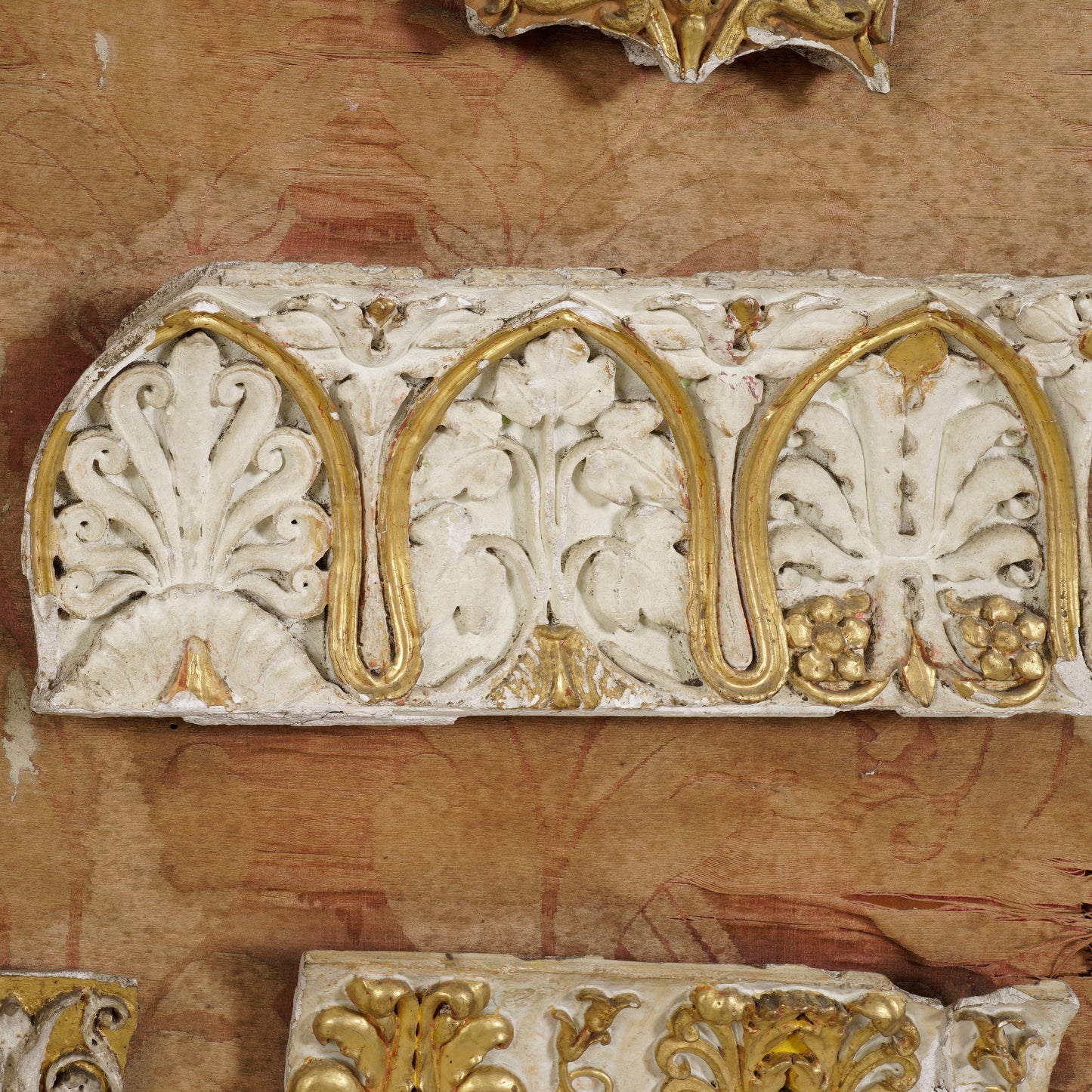 Decorative architectural element with gold and white patterns on a textured background