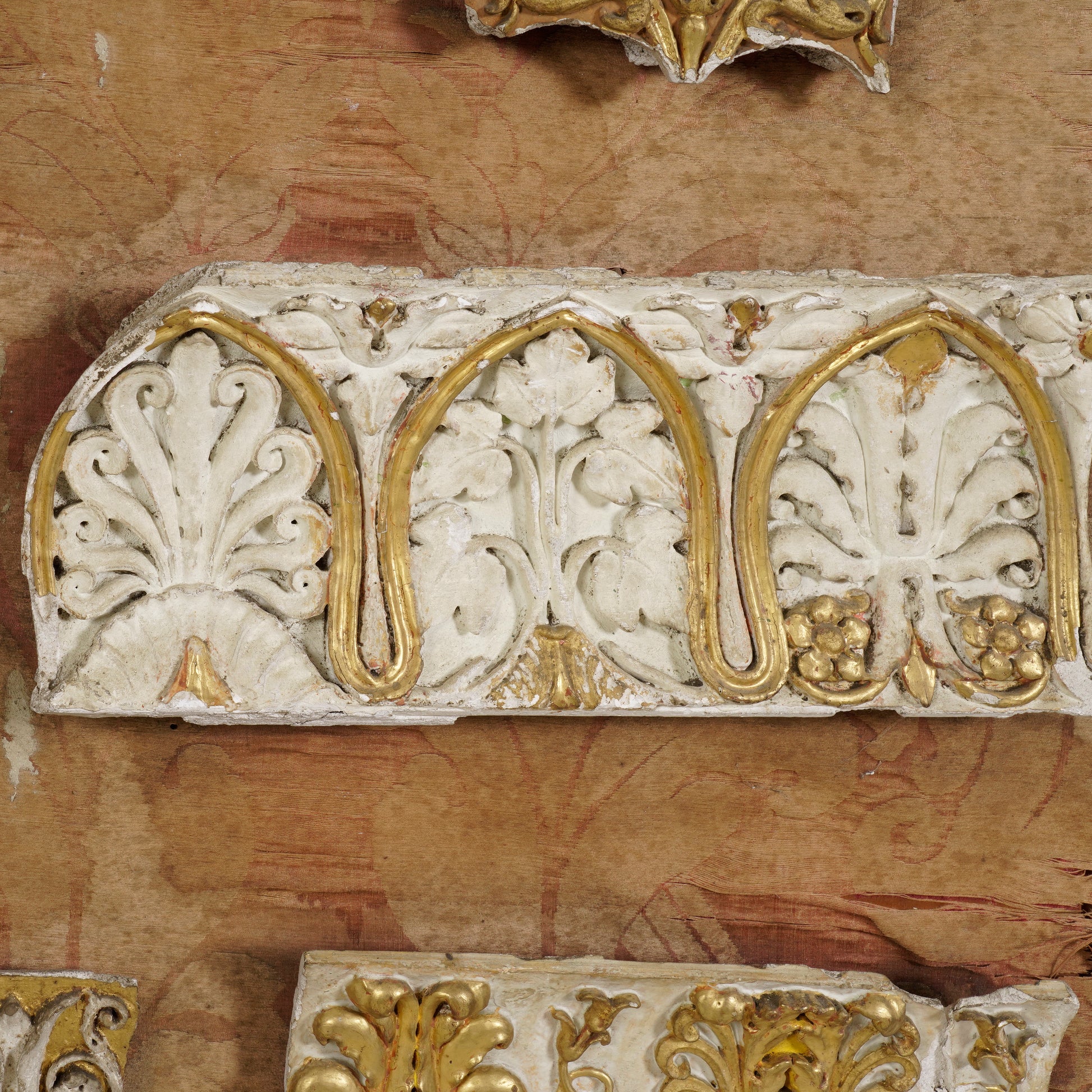 Decorative architectural element with gold and white patterns on a textured background