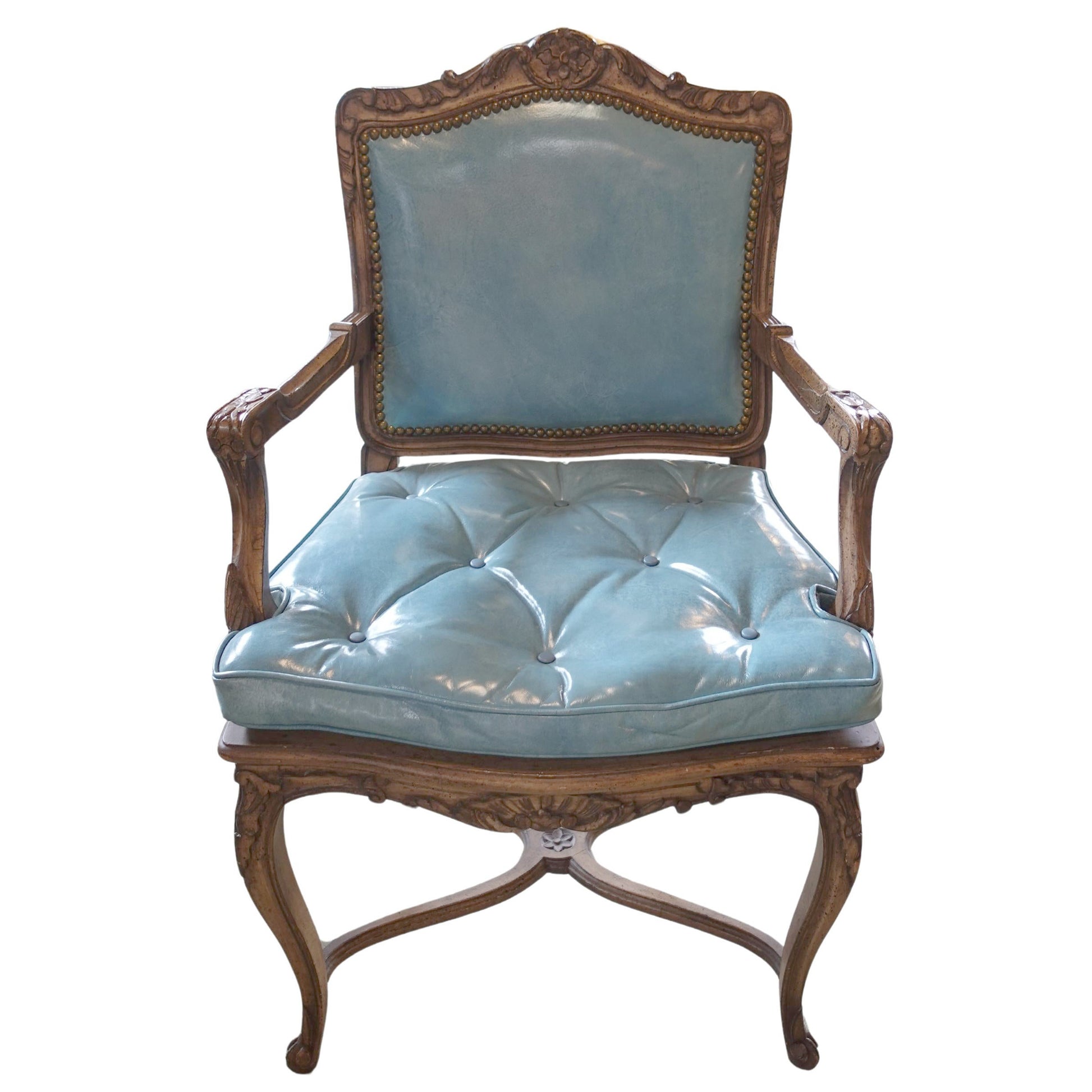 Vintage chair with light blue cushioned seat and backrest on a white background