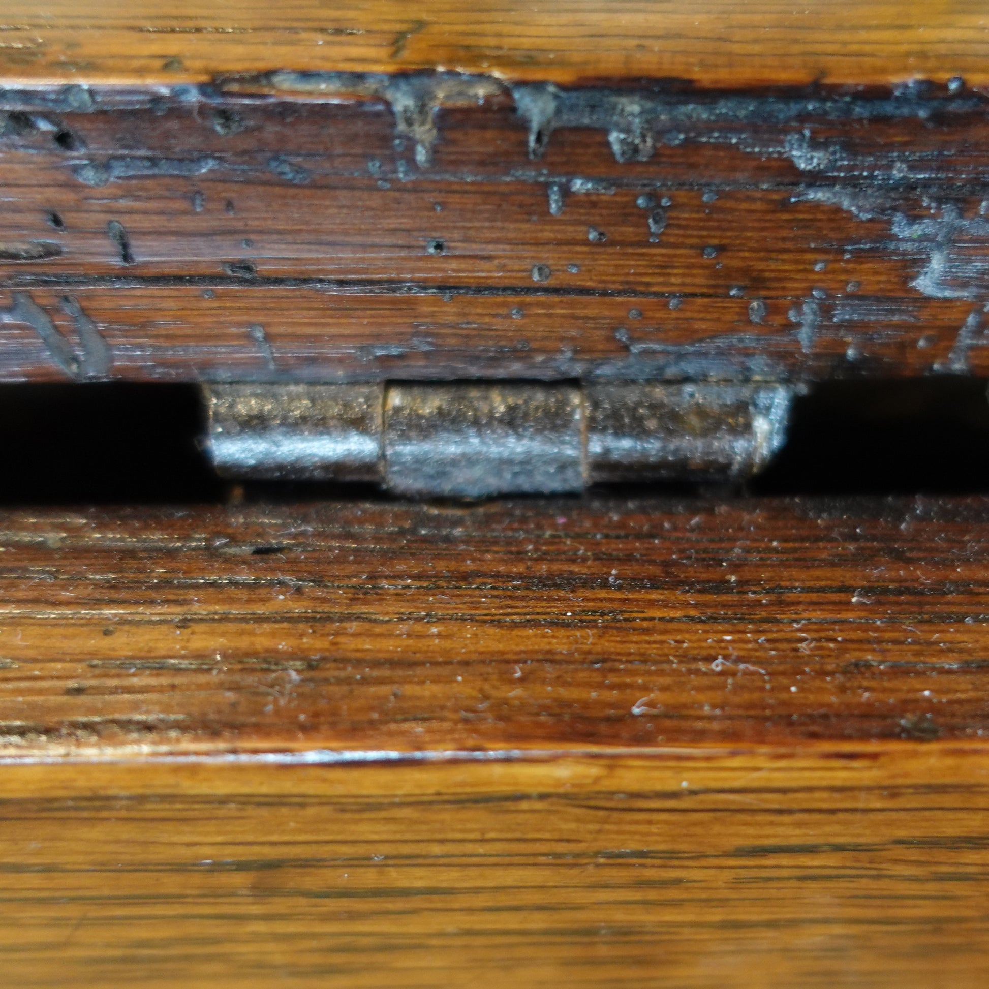 Close-up of a wooden surface with a metal latch