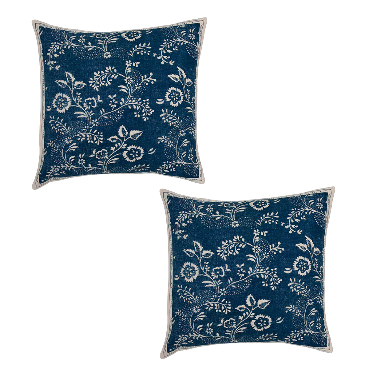 Two blue pillows with white floral patterns on a white background